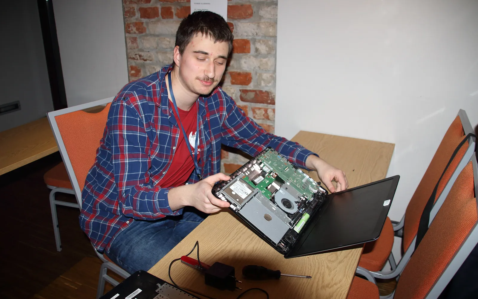 Technician working on an open laptop at a desk